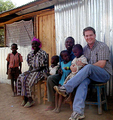 Photo of Chris Barrett visiting farming family in Kampi ya Wakulima, Kenya